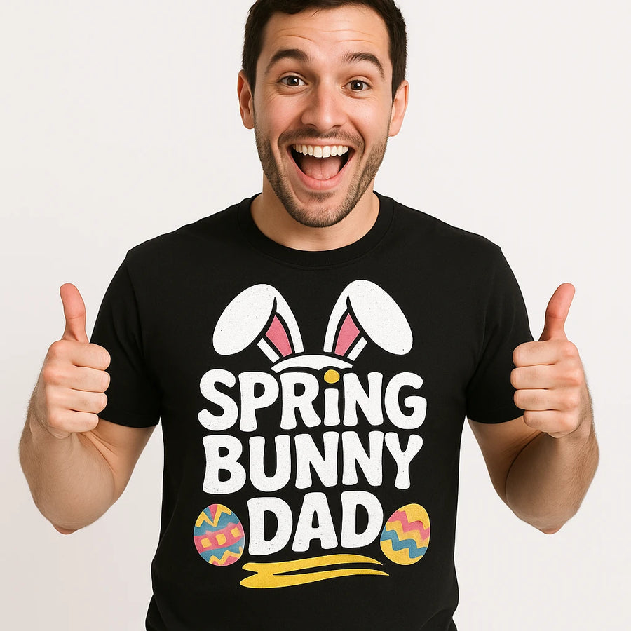 A smiling person wearing a black t-shirt that says "SPRING BUNNY DAD" with bunny ears and colorful eggs graphic. The person is giving two thumbs up.