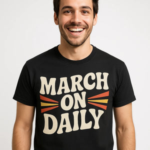 Close-up of the "March on Daily" beige print on a premium Bella+Canvas black activism t shirt