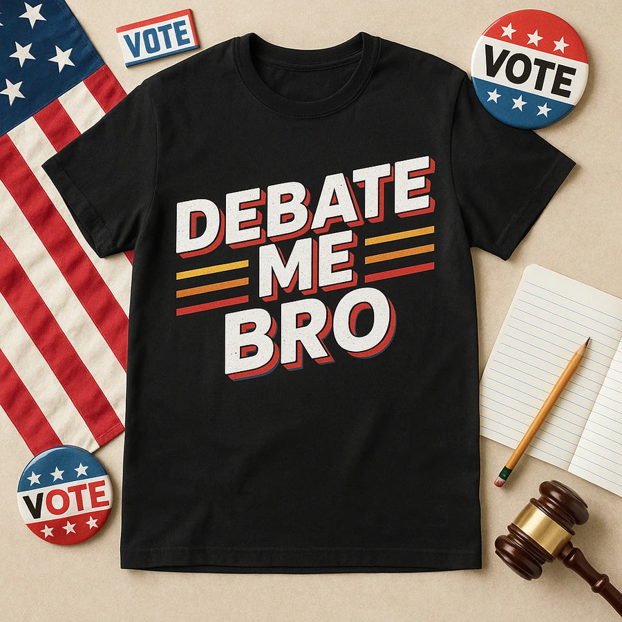 A flat lay featuring a black t-shirt with the text "DEBATE ME BRO" in bold letters. Surrounding the t-shirt are American flag-themed items, including a "VOTE" button, a small flag, a pencil, a notepad, and a gavel, all on a neutral background.