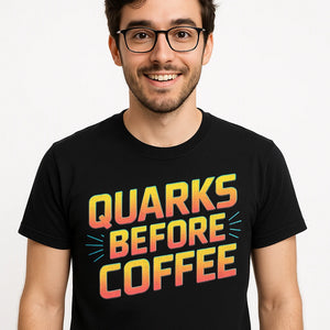 Close-up of the "Quarks Before Coffee" orange print on a premium Bella+Canvas black physics t shirt