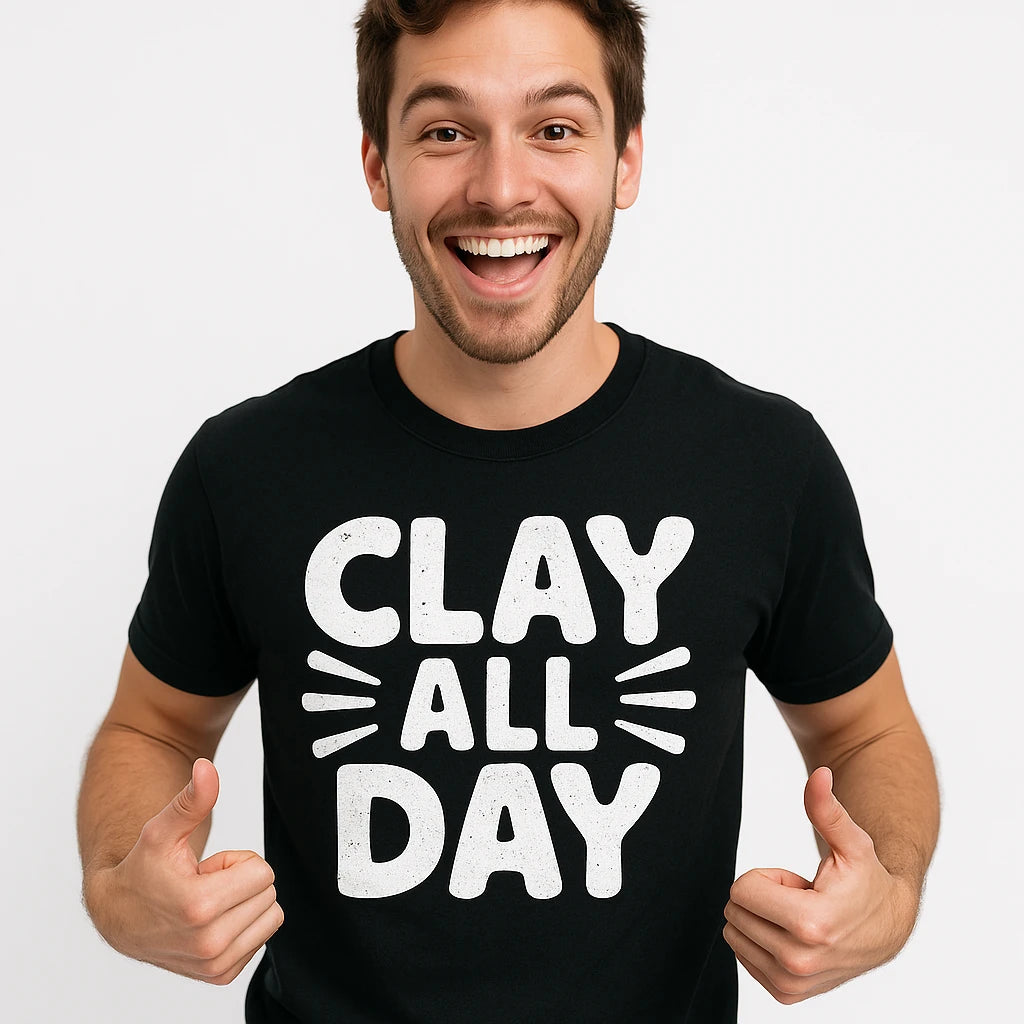 Close-up of the "Clay All Day" white print on a premium Bella+Canvas black men's body sculpting t shirt