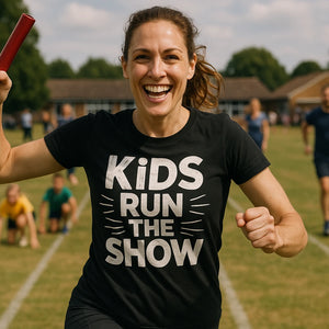 Lifestyle shot of the "Kids Run the Show" black family life t shirt in a real-world setting