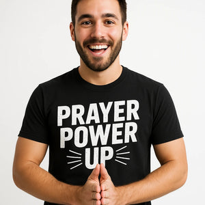 Close-up of the "Prayer Power Up" white print on a premium Bella+Canvas black faith shirts