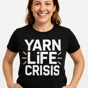 Close-up of the "Yarn Life Crisis" white print on a premium Bella+Canvas black knitting shirts