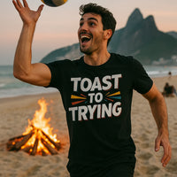 A person is on a beach, joyfully playing with a ball. They are wearing a black t-shirt with the text 