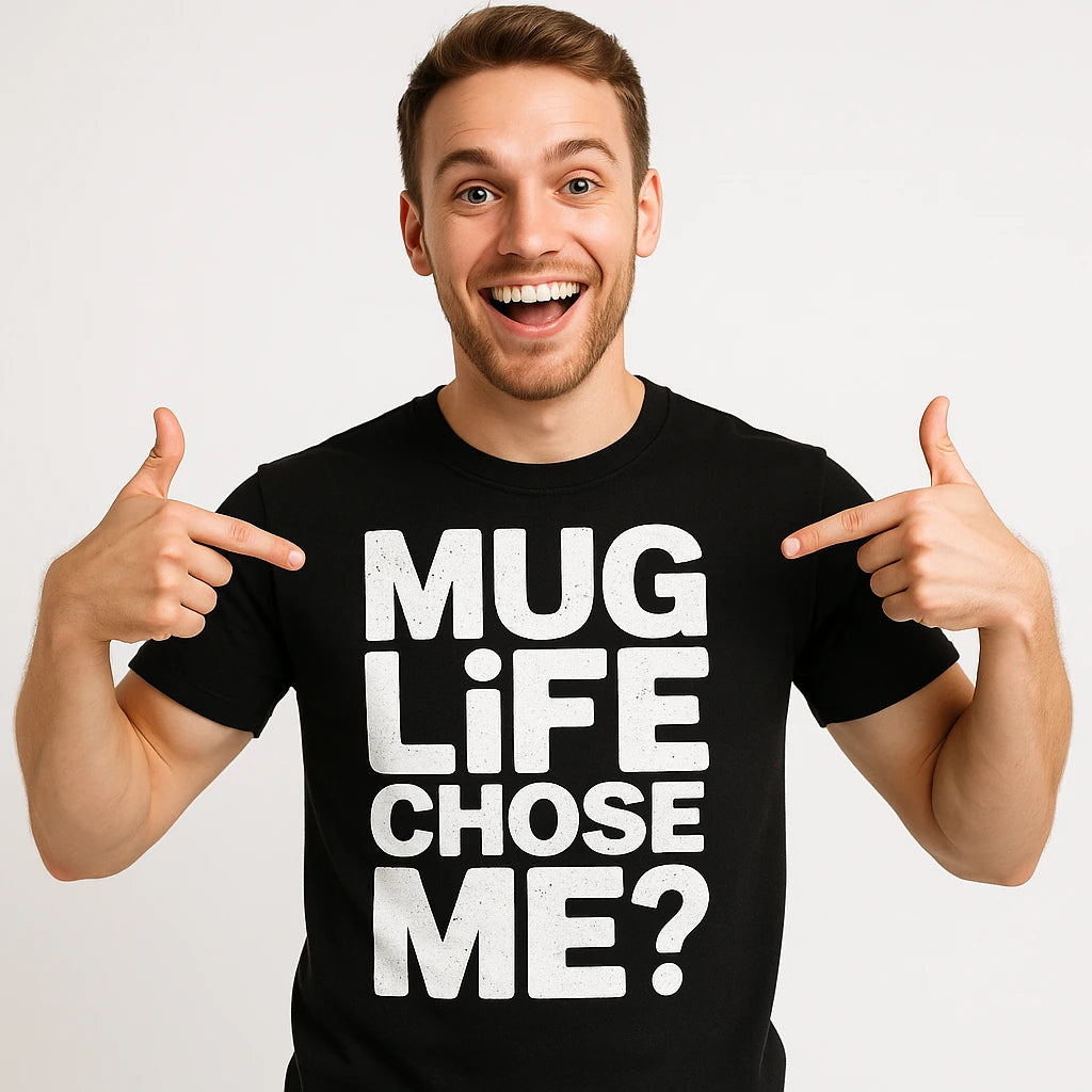 A smiling person with short hair is pointing at their black T-shirt, which has the text "MUG LIFE CHOSE ME?" in bold white letters.