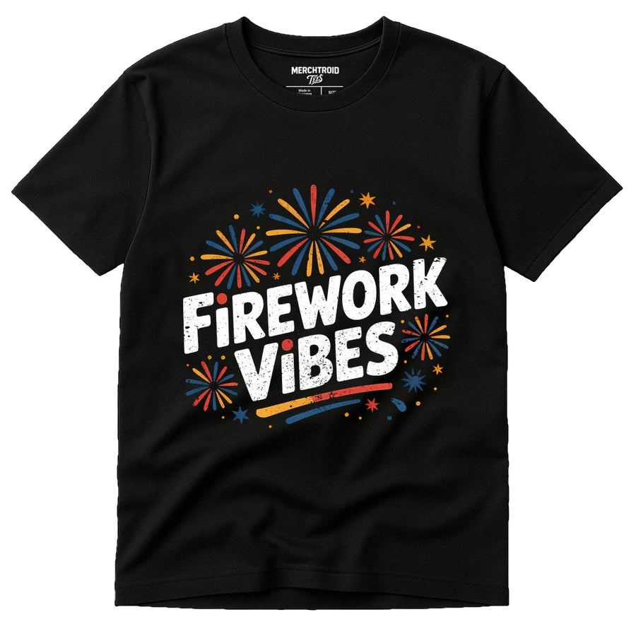 A black t-shirt with colorful fireworks graphics surrounding the bold, white text "Firework Vibes." The design features red, yellow, and blue fireworks, creating a festive theme.