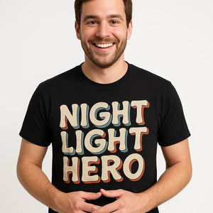 Close-up of the "Night Light Hero" beige print on a premium Bella+Canvas black new parents shirts