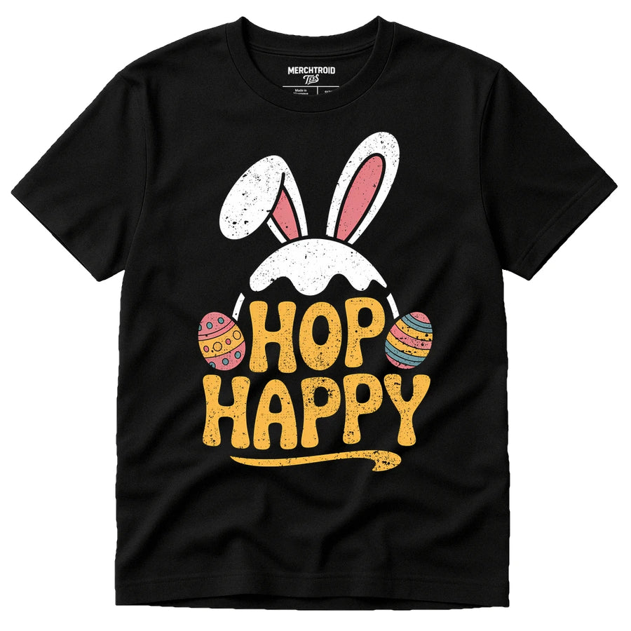 A black t-shirt featuring a whimsical design of white and pink bunny ears above the phrase "HOP HAPPY" in large yellow letters. There are colorful Easter eggs flanking the text.
