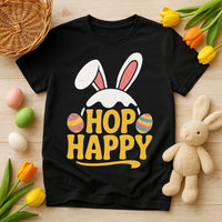 A black t-shirt is laid flat with a design featuring bunny ears and colorful Easter eggs around the words 