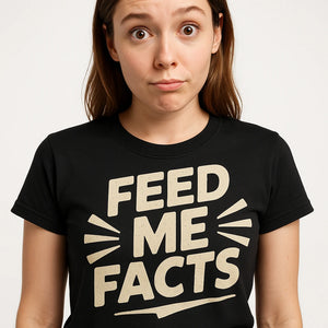 Close-up of the "Feed Me Facts" beige print on a premium Bella+Canvas black studying t shirt