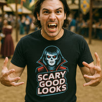 A person with long hair is making a playful, intense expression, showing prominent canine teeth resembling vampire fangs. They are wearing a black T-shirt featuring an illustration of a vampire-like figure and the text 