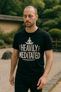 A person with a shaved head and beard is wearing a black t-shirt with the text 