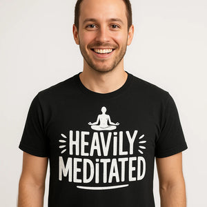 Close-up of the "Heavily Meditated" white print on a premium Bella+Canvas black meditation shirts