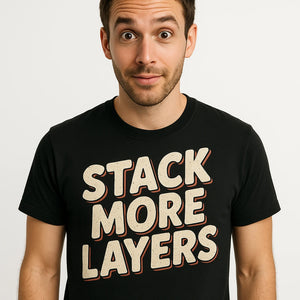 Close-up of the "Stack More Layers" beige print on a premium Bella+Canvas black artificial intelligence t shirt