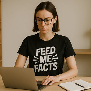 Lifestyle shot of the "Feed Me Facts" black studying t shirt in a real-world setting