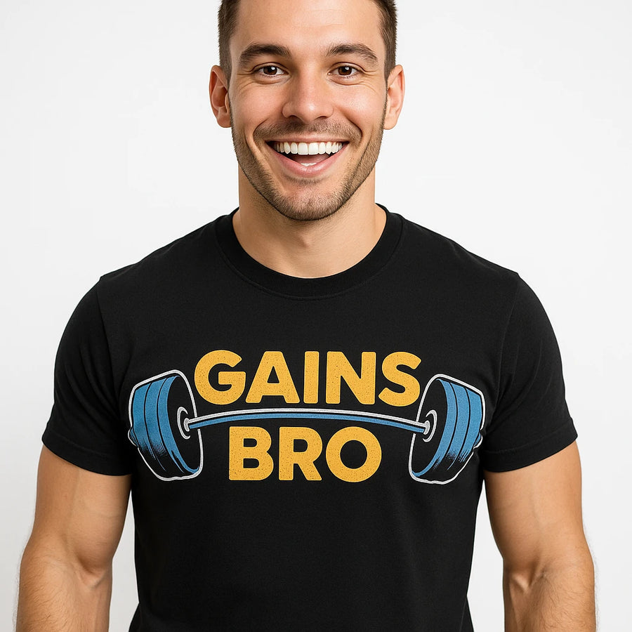 A person wearing a black t-shirt with the text "GAINS BRO" in bold yellow letters, accompanied by an illustration of a barbell. The person is smiling and looking directly at the camera, with short hair and a fit build. The background is plain white.