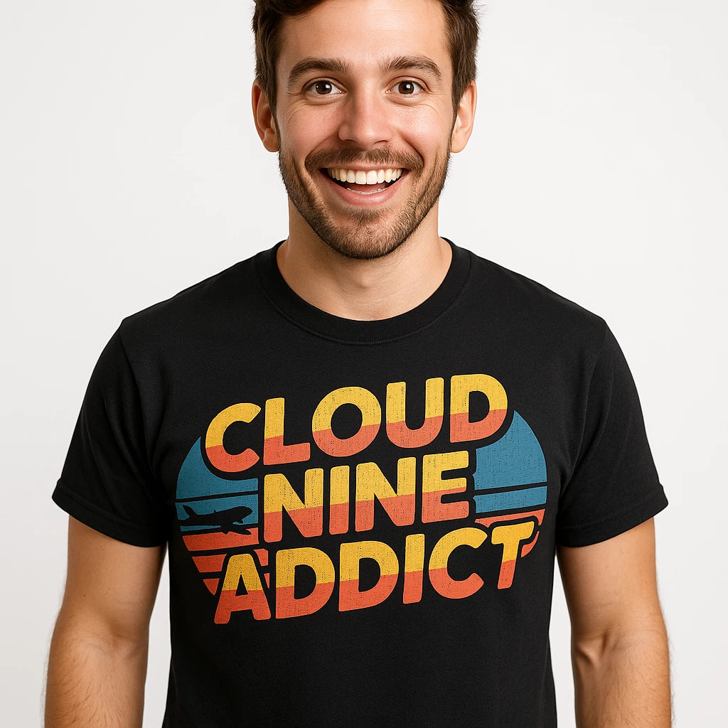 Close-up of the "Cloud Nine Addict" orange print on a premium Bella+Canvas black flying t shirt