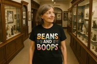 A person with grey hair is wearing a black T-shirt with colorful text that reads 