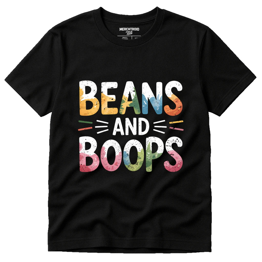 A black t-shirt with colorful, distressed text that reads "BEANS AND BOOPS" in large, bold letters. The colors of the text include yellow, orange, blue, green, and pink, with decorative lines around "AND." The brand label "Merchtroid" is visible on the inside neck area of the shirt.