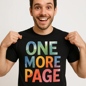 Close-up of the "One More Page" tan print on a premium Bella+Canvas black reading shirts
