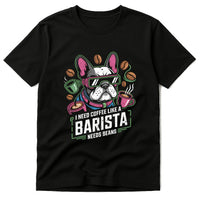 Black T-shirt featuring an illustration of a dog wearing sunglasses and a colorful scarf. The design is surrounded by coffee cups and coffee beans. The dog has a playful expression, and the design uses vibrant colors.