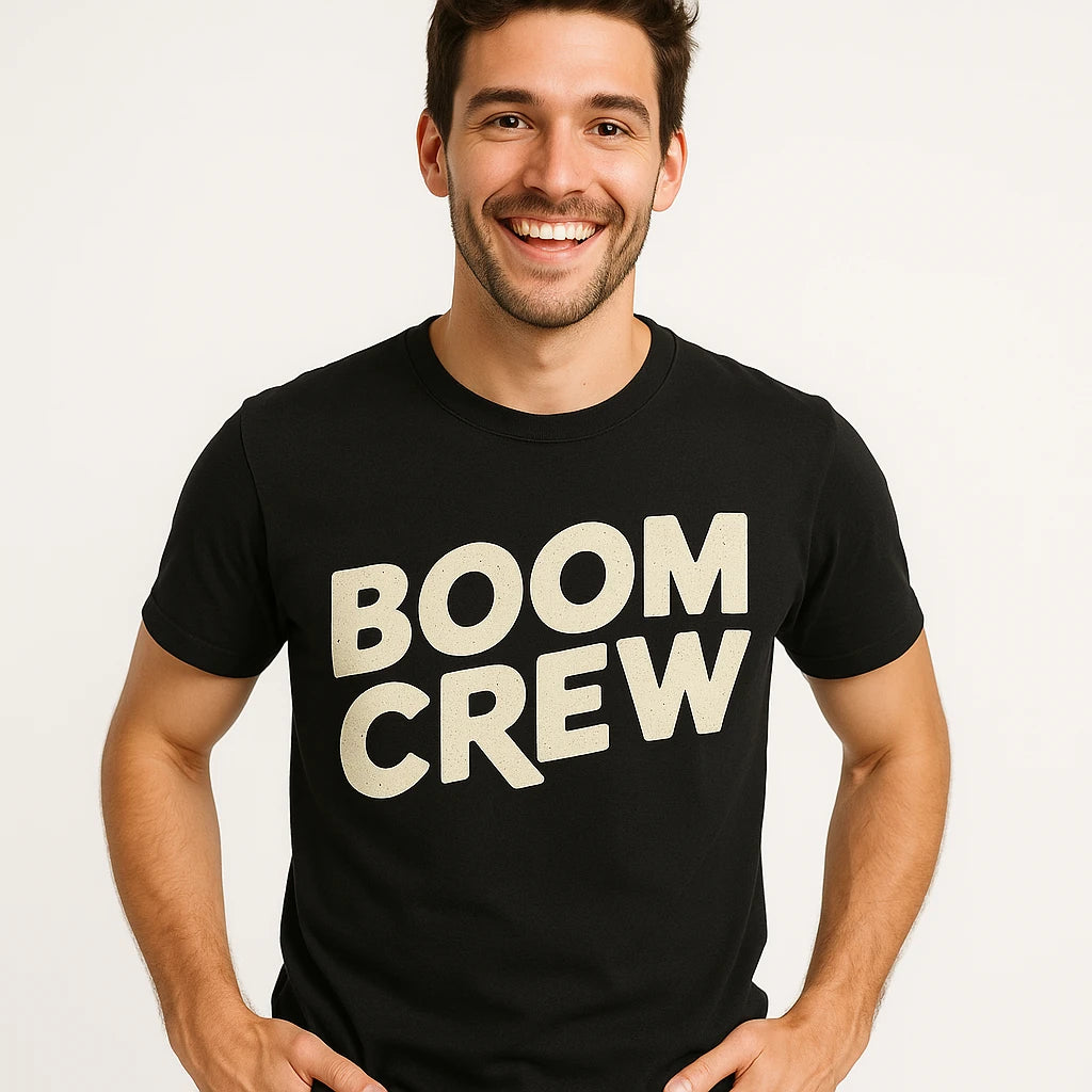 Close-up of the "Boom Crew" beige print on a premium Bella+Canvas black storms t shirt