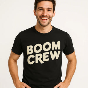 Close-up of the "Boom Crew" beige print on a premium Bella+Canvas black storms t shirt