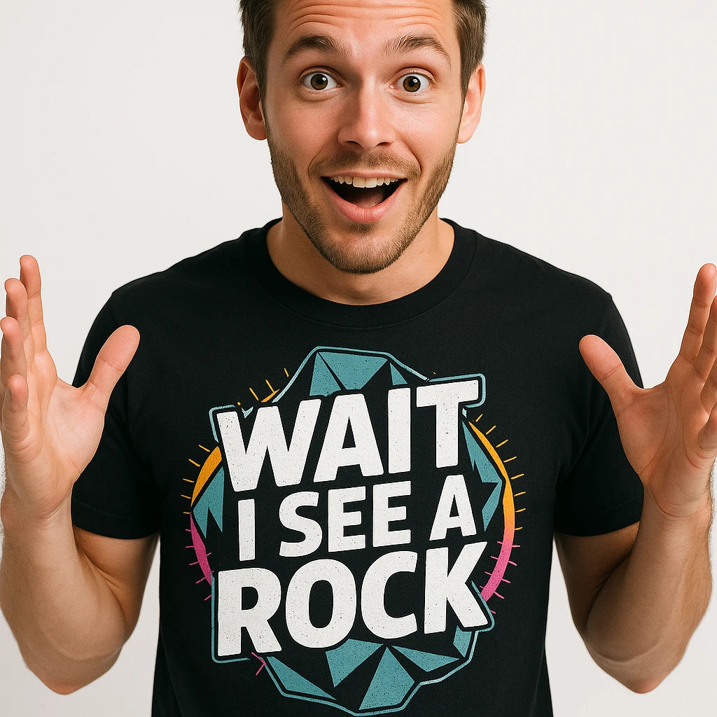 Close-up of the "Wait I See a Rock" white print on a premium Bella+Canvas black rock hounding shirts
