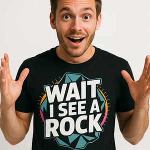 Close-up of the "Wait I See a Rock" white print on a premium Bella+Canvas black rock hounding shirts
