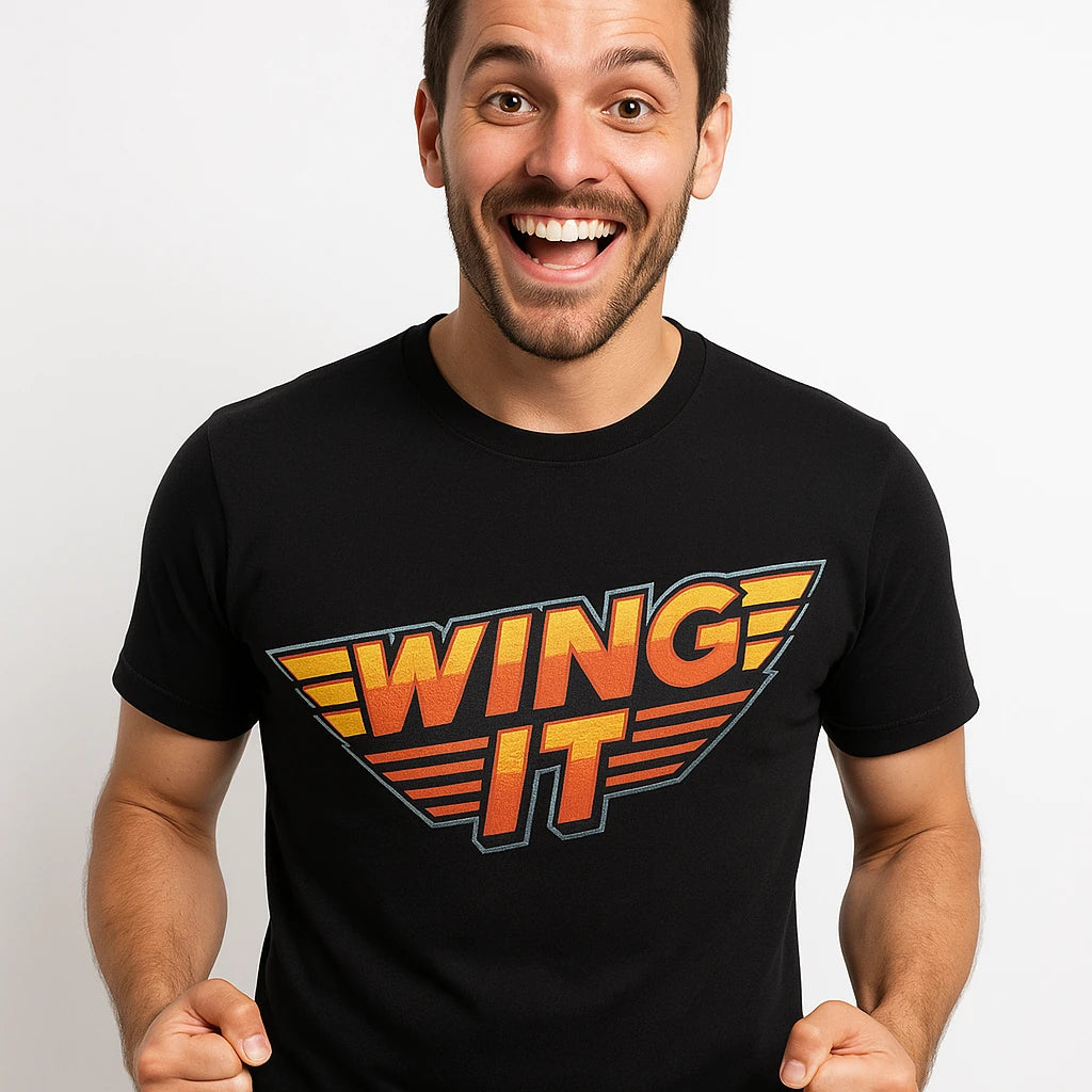 Close-up of the "Wing It" orange print on a premium Bella+Canvas black hawks shirts