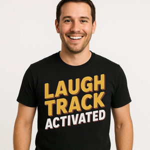 Close-up of the "Laugh Track Activated" gold print on a premium Bella+Canvas black daddy shirts