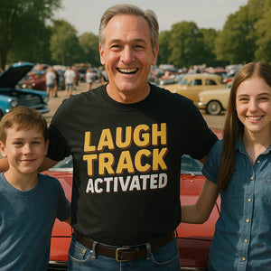 Lifestyle shot of the "Laugh Track Activated" black daddy shirts in a real-world setting