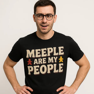 Close-up of the "Meeple Are My People" beige print on a premium Bella+Canvas black board game tshirts