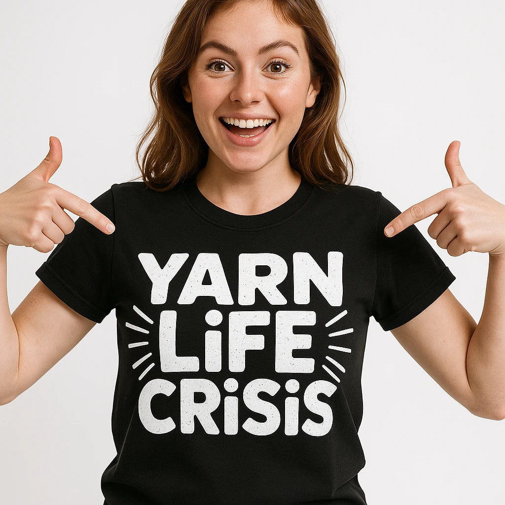 Close-up of the "Yarn Life Crisis" white print on a premium Bella+Canvas black mens knitted t shirt