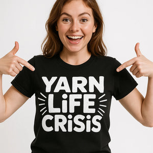 Close-up of the "Yarn Life Crisis" white print on a premium Bella+Canvas black mens knitted t shirt