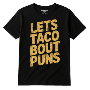 Black Comedy Tshirts - "Lets Taco Bout Puns" graphic tee with gold print, flat lay product photo