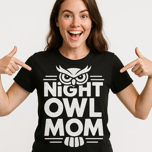 Close-up of the "Night Owl Mom" white print on a premium Bella+Canvas black owl t shirt