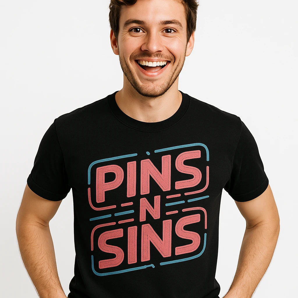 Close-up of the "Pins N Sins" pink print on a premium Bella+Canvas black fashion designer shirts