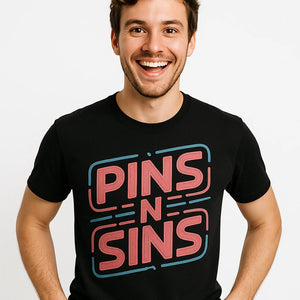 Close-up of the "Pins N Sins" pink print on a premium Bella+Canvas black fashion designer shirts