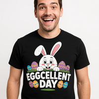 A person wearing a black T-shirt with a design featuring a cartoon bunny surrounded by colorful Easter eggs. The person is smiling broadly.