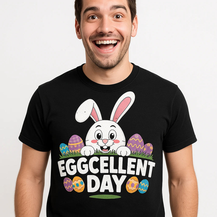 A person wearing a black T-shirt with a design featuring a cartoon bunny surrounded by colorful Easter eggs. The person is smiling broadly.