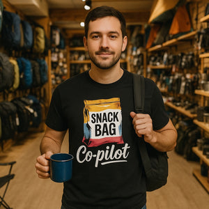 Lifestyle shot of the "Snack Bag Copilot" black road trip t shirt in a real-world setting