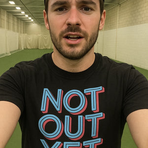 "Not Out Yet" black cricket shirts, photographed as presents for cricket lovers