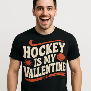 Close-up of the "Hockey Is My Valentine" beige print on a premium Bella+Canvas black field hockey shirts