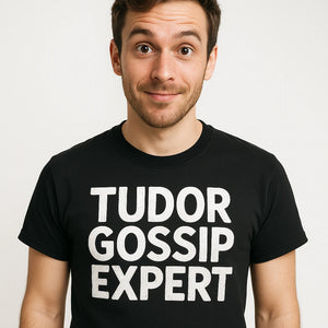 Close-up of the "Tudor Gossip Expert" white print on a premium Bella+Canvas black history tees