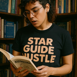 "Star Guide Hustle" black astrology shirts, photographed as presents for astrology lovers