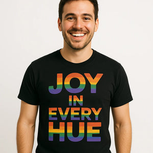 Close-up of the "Joy in Every Hue" orange print on a premium Bella+Canvas black t shirt lgbtq