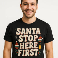 A person is smiling while wearing a black shirt with the text 