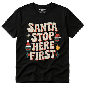 Black Christmas Tee Shirts For Family - "Santa Stop Here First" graphic tee with beige print, flat lay product photo